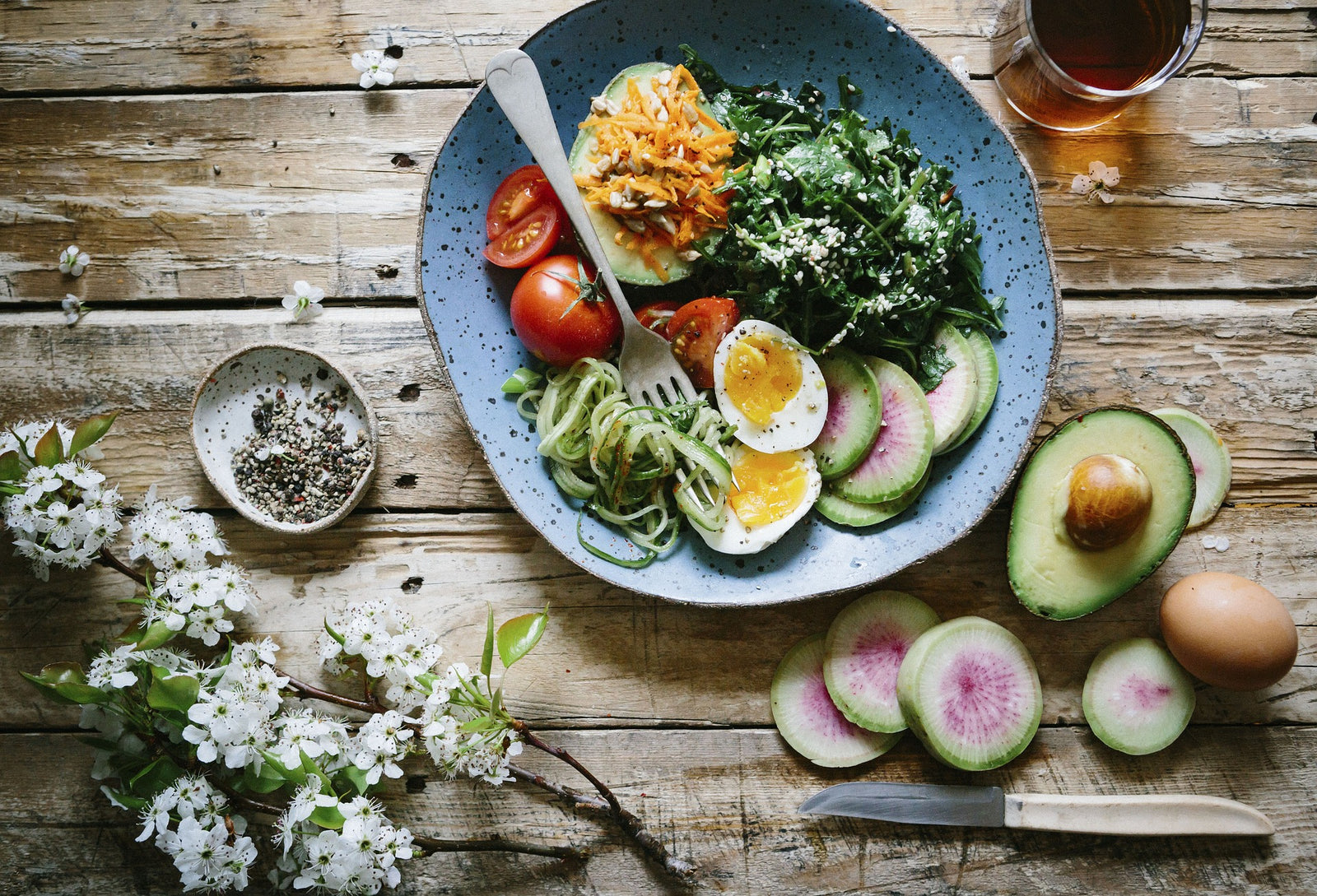 Quinoa bowl with vegetables, avocado, and soft-boiled egg.