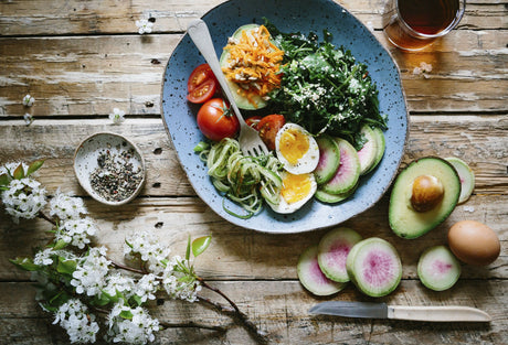 Quinoa bowl with vegetables, avocado, and soft-boiled egg.