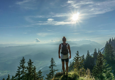 Person hiking in the mountains, embracing the mental health benefits of outdoor activities